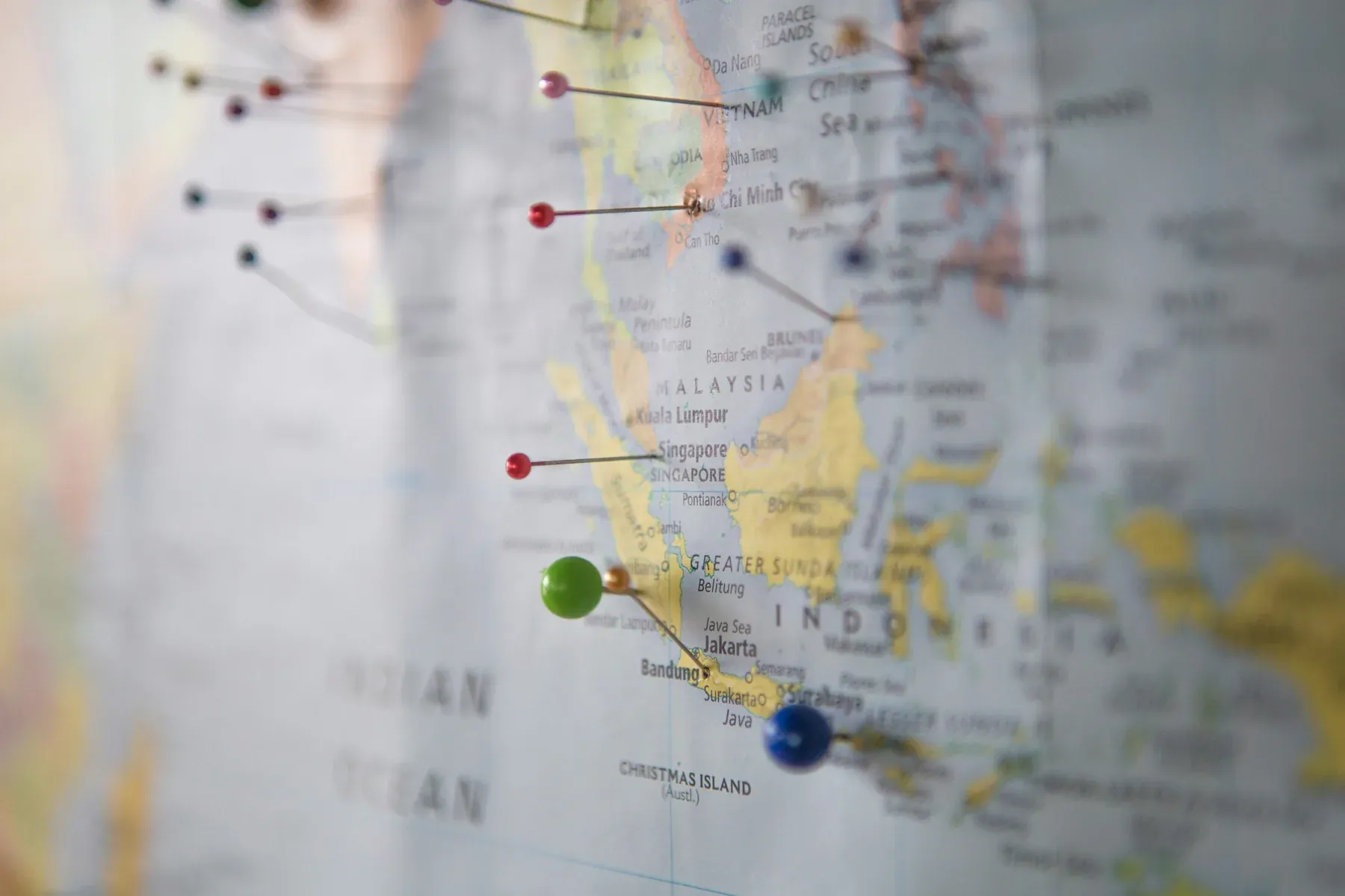 World map with coloured pins marking travel destinations